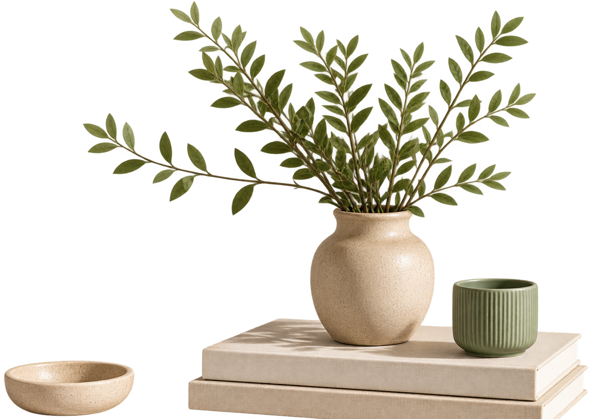 A decorative arrangement of a ceramic vase with greenery on a stack of books, representing organized, well-kept records